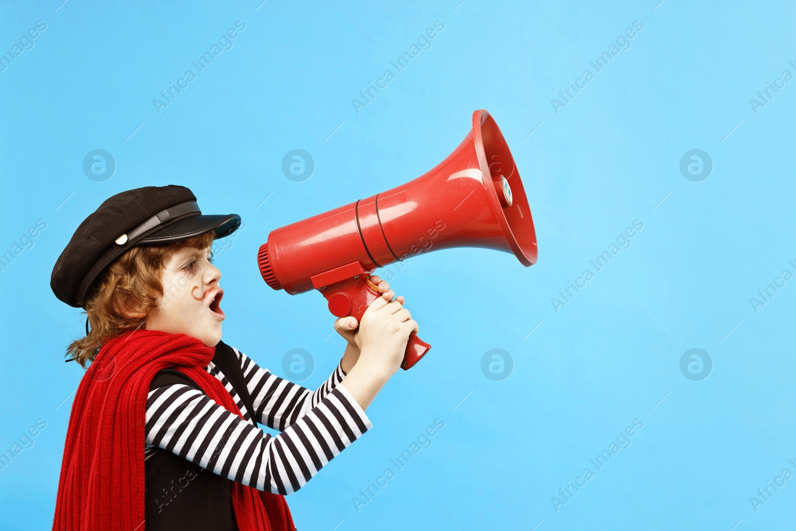 Photo of Cute boy in mime costume shouting in megaphone on light blue background, space for text. Surprise party