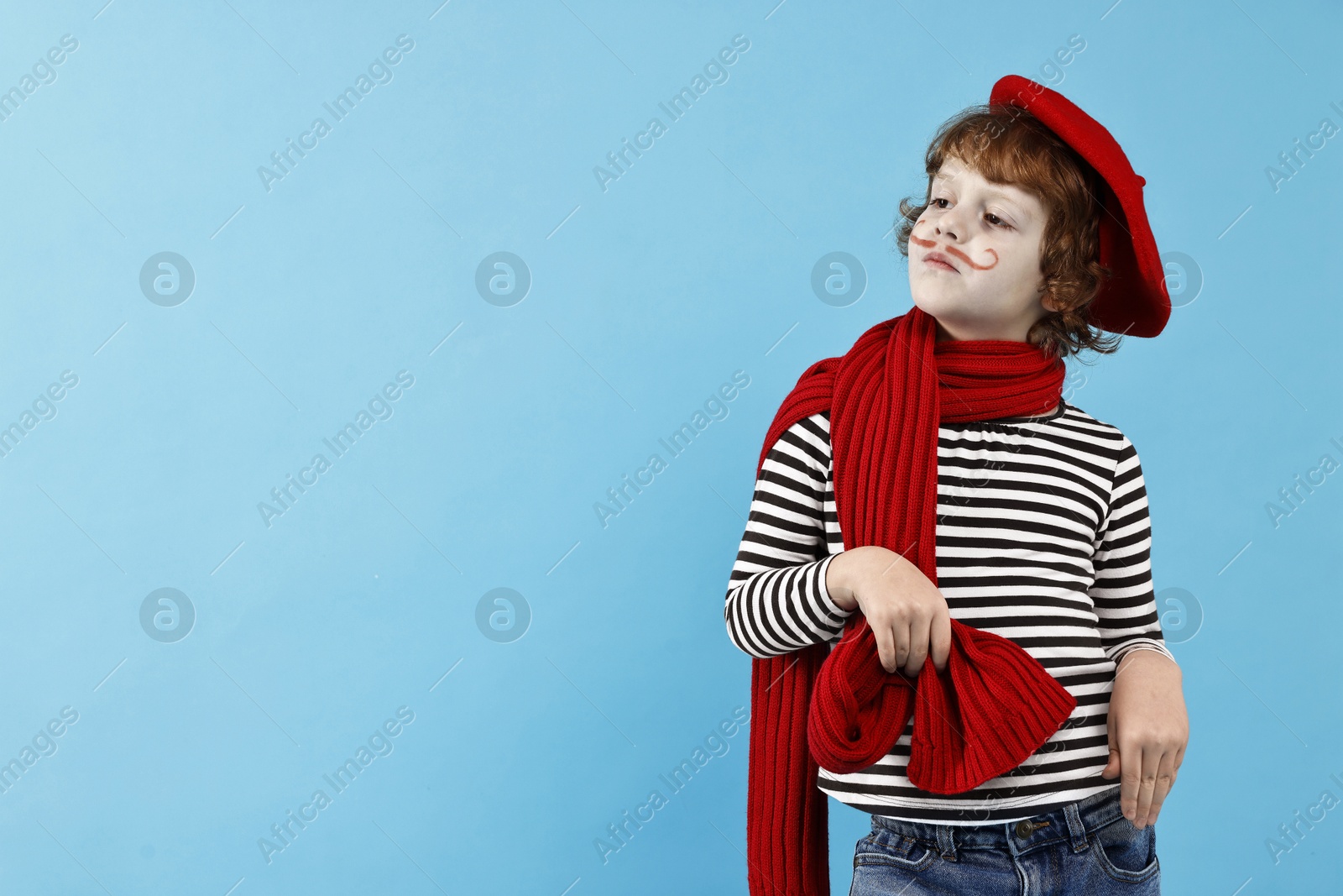 Photo of Cute boy in mime costume on light blue background, space for text. Surprise party