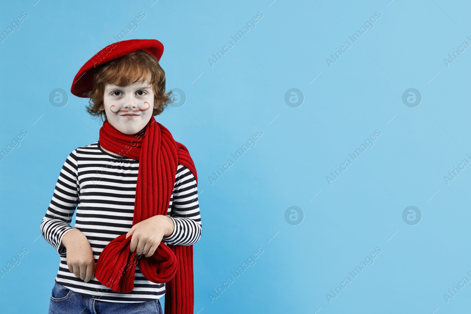 Photo of Cute boy in mime costume on light blue background, space for text. Surprise party