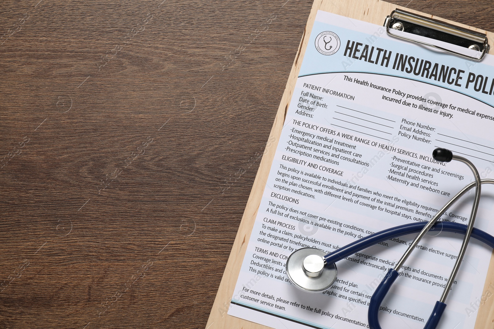 Photo of Health insurance policy form and stethoscope on wooden table, top view. Space for text