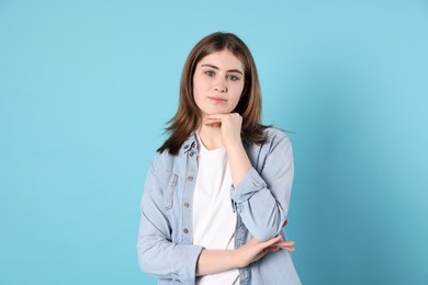 Photo of Portrait of beautiful teenage girl on light blue background