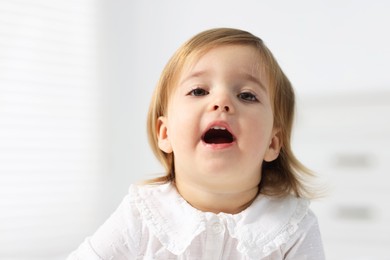 Photo of Portrait of cute little baby girl on light background