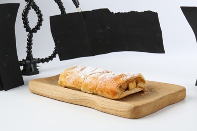 Photo of Delicious strudel with apples and powdered sugar isolated on white