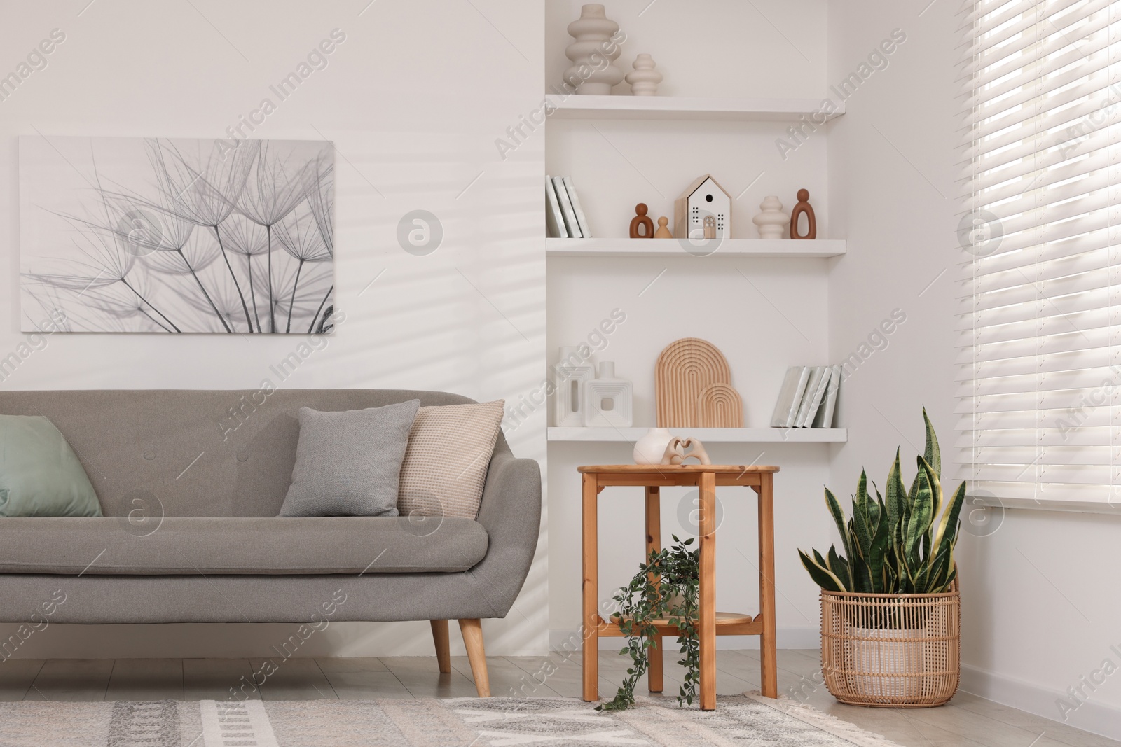 Photo of Stylish furniture, houseplants and different decor in light living room. Interior design