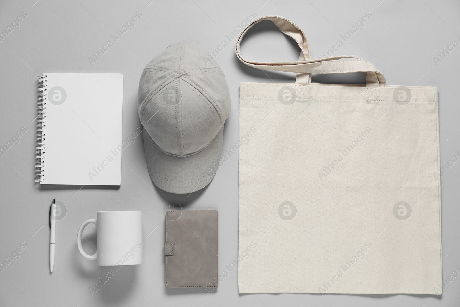 Photo of Different blank items for branding on gray background, flat lay. Mockup for design