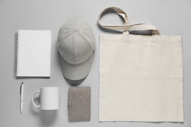 Photo of Different blank items for branding on gray background, flat lay. Mockup for design