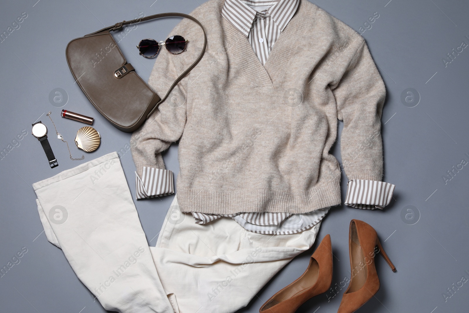 Photo of Elegant women's outfit. Stylish clothes and accessories on grey background, flat lay