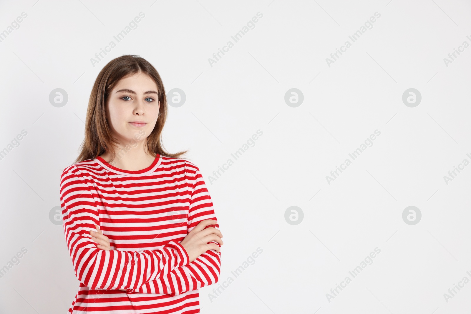 Photo of Portrait of beautiful teenage girl on light background. Space for text