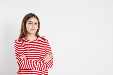 Photo of Portrait of beautiful teenage girl on light background. Space for text