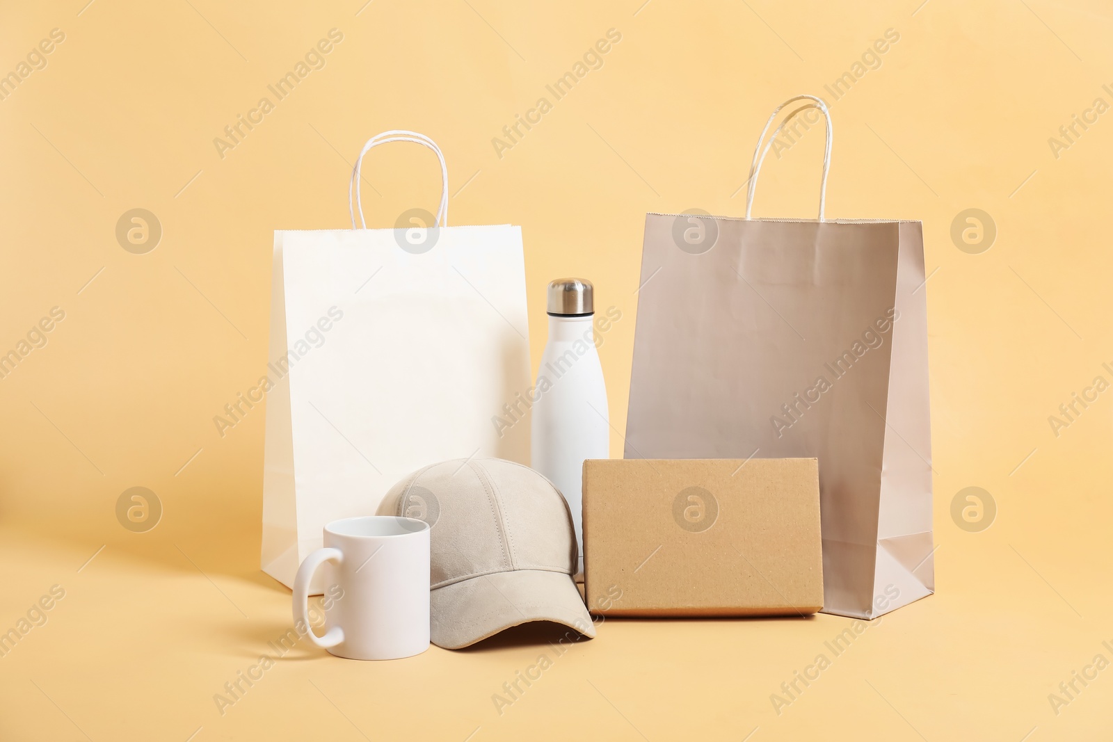 Photo of Different blank items for branding on beige background. Mockup for design