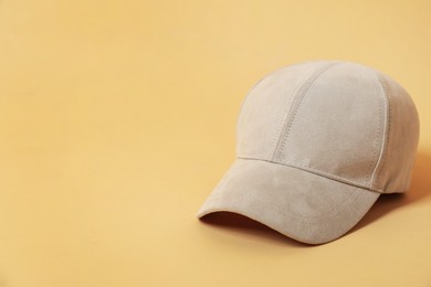 Photo of Blank baseball cap for branding on beige background. Mockup for design