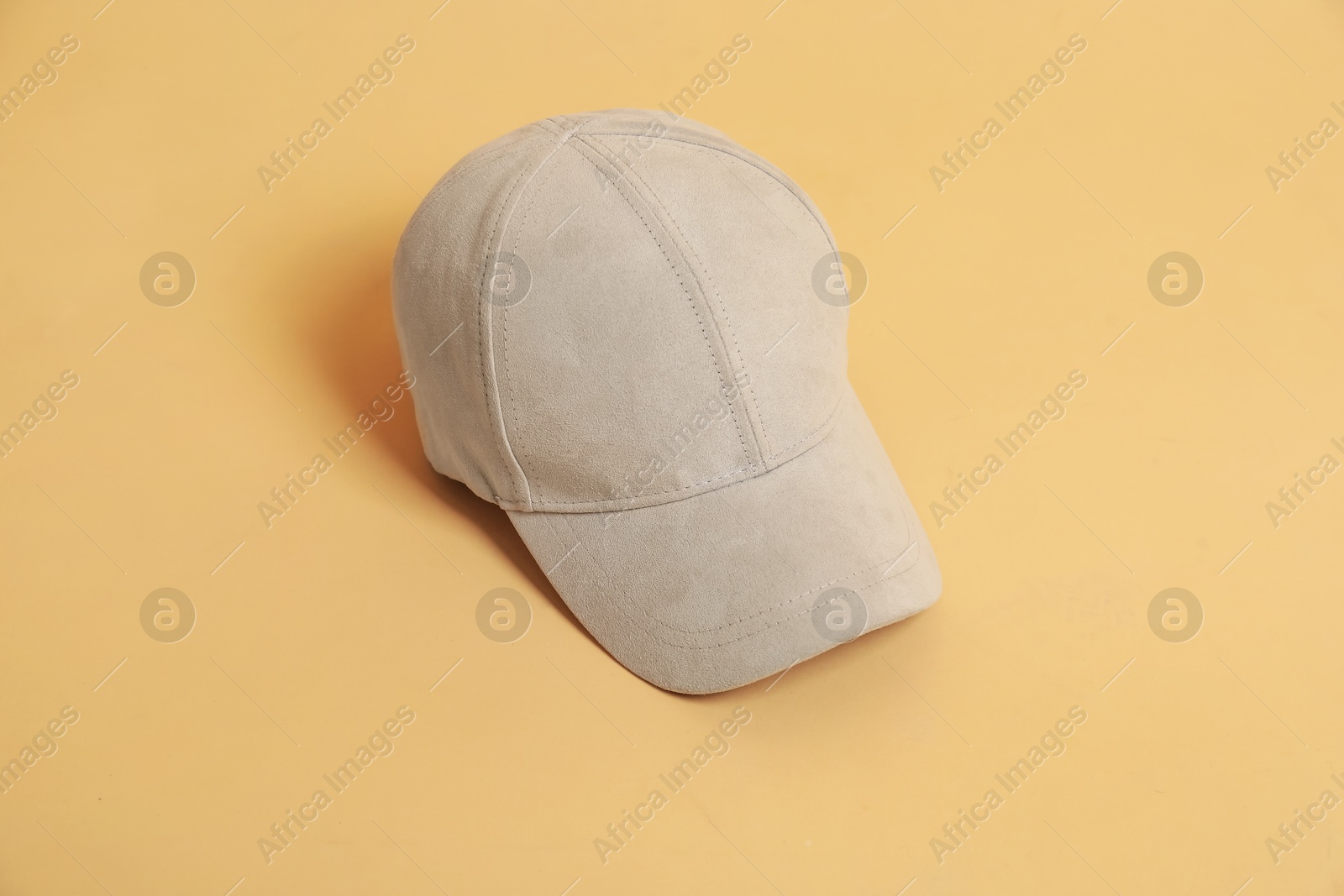 Photo of Blank baseball cap for branding on beige background. Mockup for design