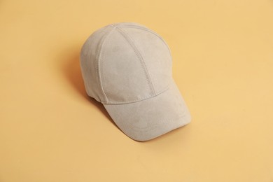 Photo of Blank baseball cap for branding on beige background. Mockup for design