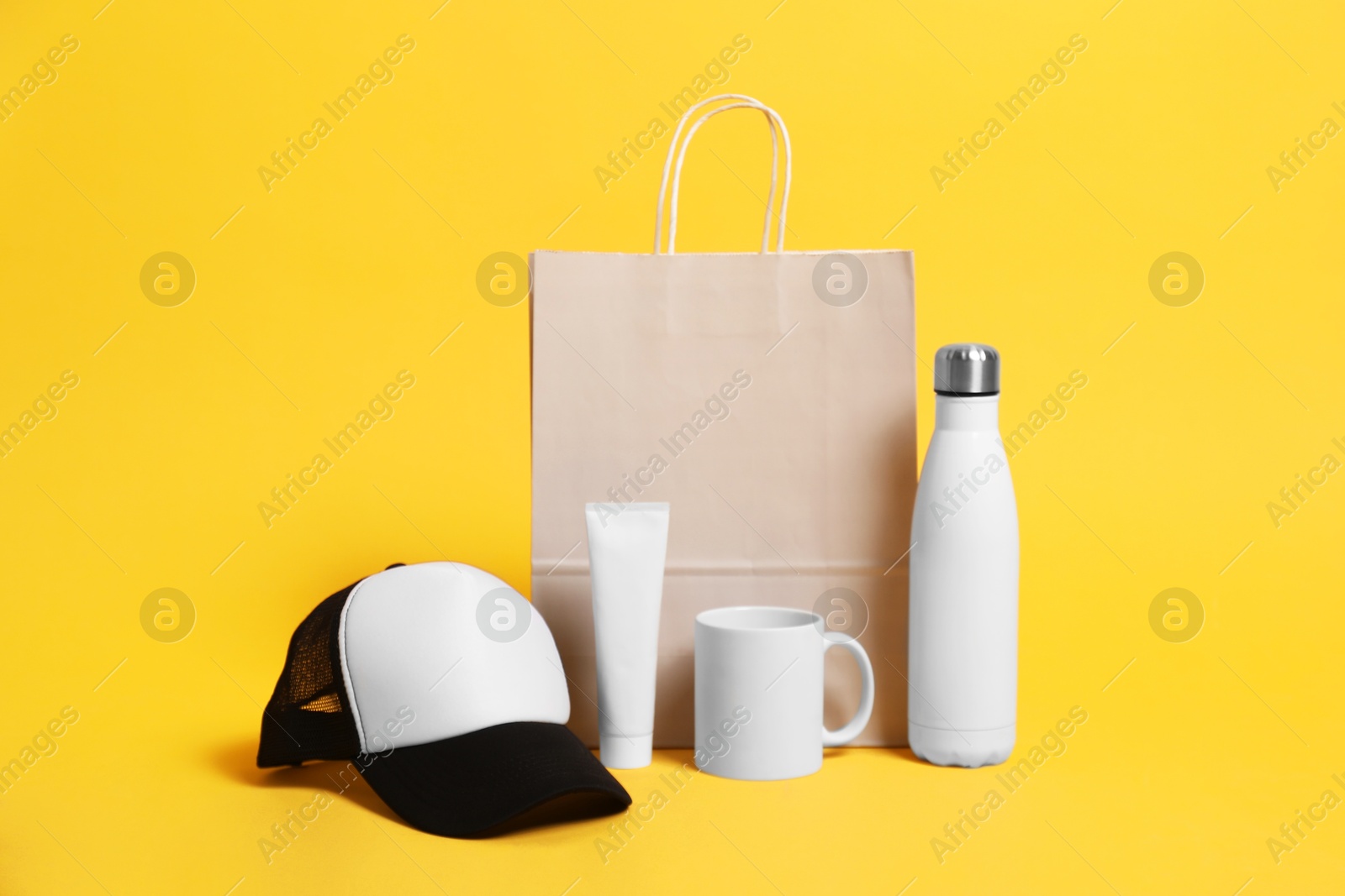 Photo of Different blank items for branding on orange background. Mockup for design