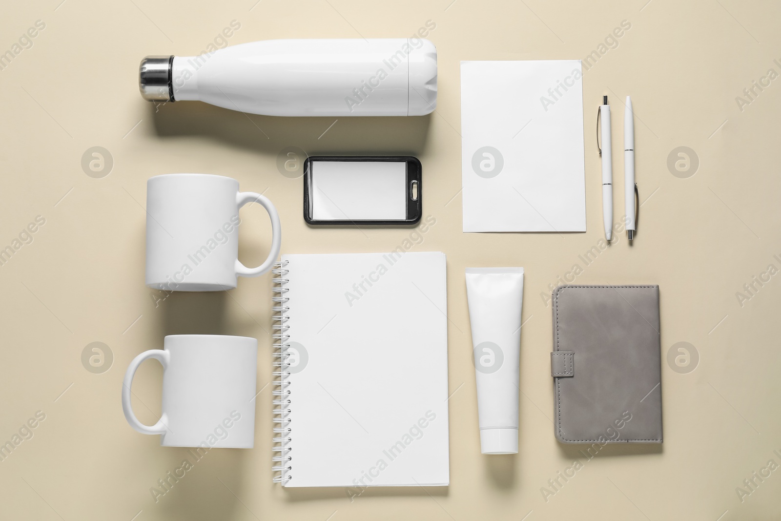 Photo of Different blank items for branding on beige background, flat lay. Mockup for design