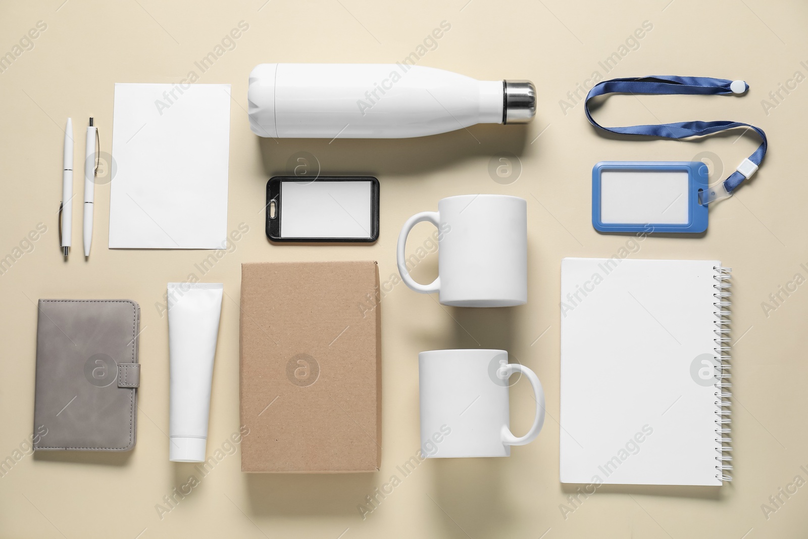 Photo of Different blank items for branding on beige background, flat lay. Mockup for design