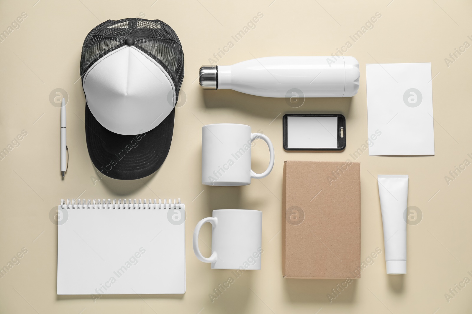 Photo of Different blank items for branding on beige background, flat lay. Mockup for design