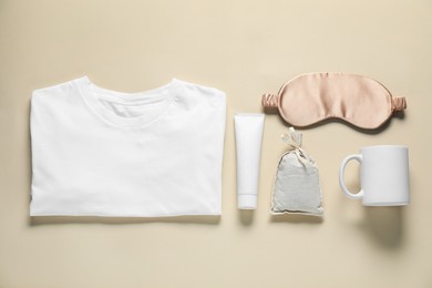 Photo of Different blank items for branding on beige background, flat lay. Mockup for design