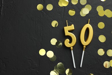 Photo of 50th birthday. Number shaped candles and confetti on black background, flat lay. Space for text