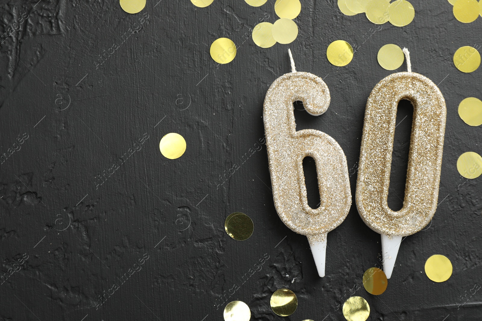 Photo of 60th birthday. Number shaped candles and confetti on black background, flat lay. Space for text