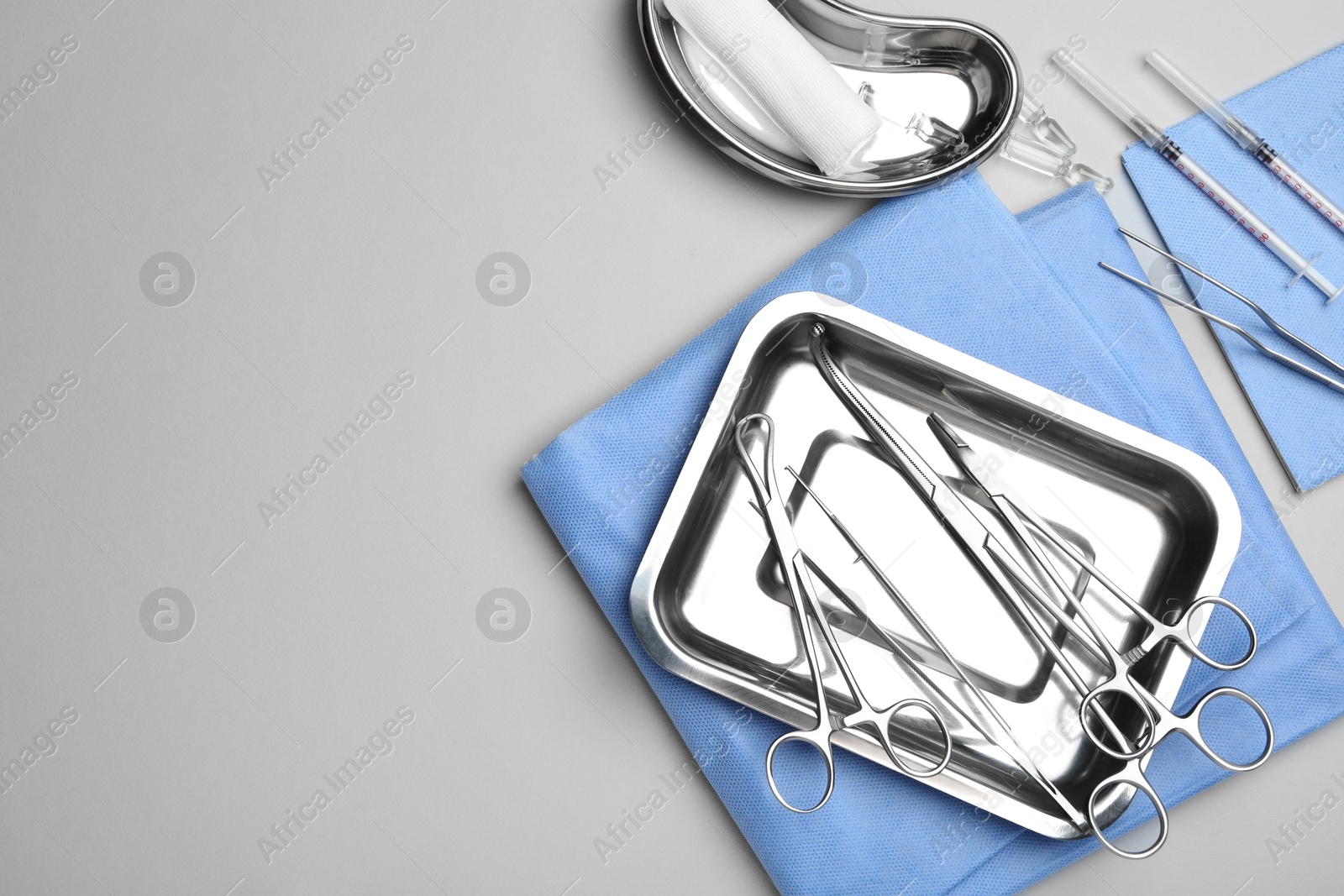 Photo of Different surgical tools on light gray background, flat lay. Space for text