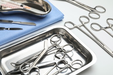 Different surgical tools on light gray background, closeup