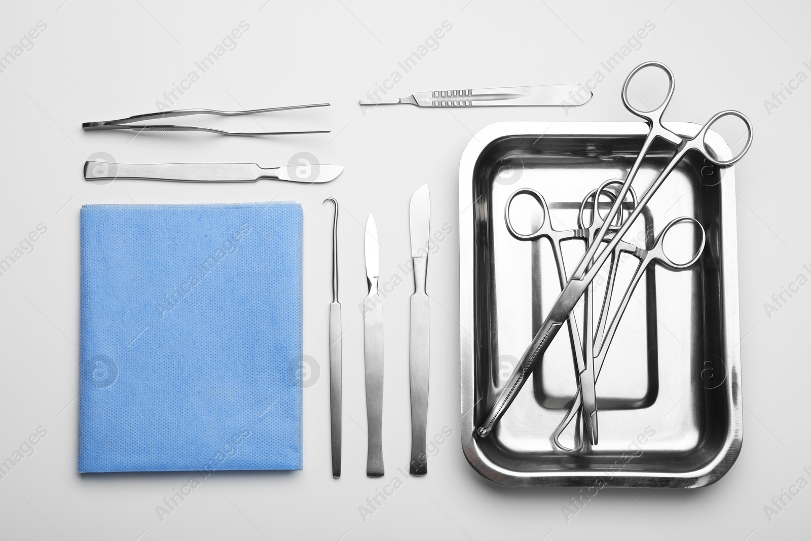 Photo of Different surgical tools on light gray background, flat lay