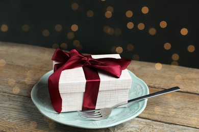 Photo of Beautiful table setting with romantic gift on wooden background, closeup