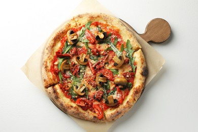 Photo of Tasty pizza with mushrooms, tomatoes and arugula on white table, top view