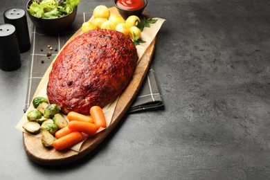 Delicious turkey meatloaf with vegetables on grey table. Space for text