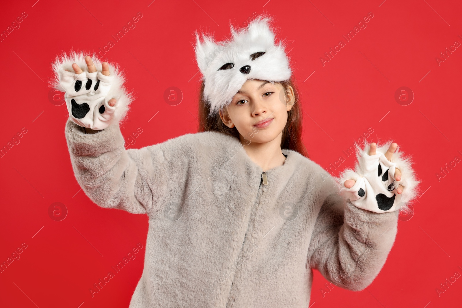 Photo of Quadrobics. Girl wearing cat mask and gloves on red background