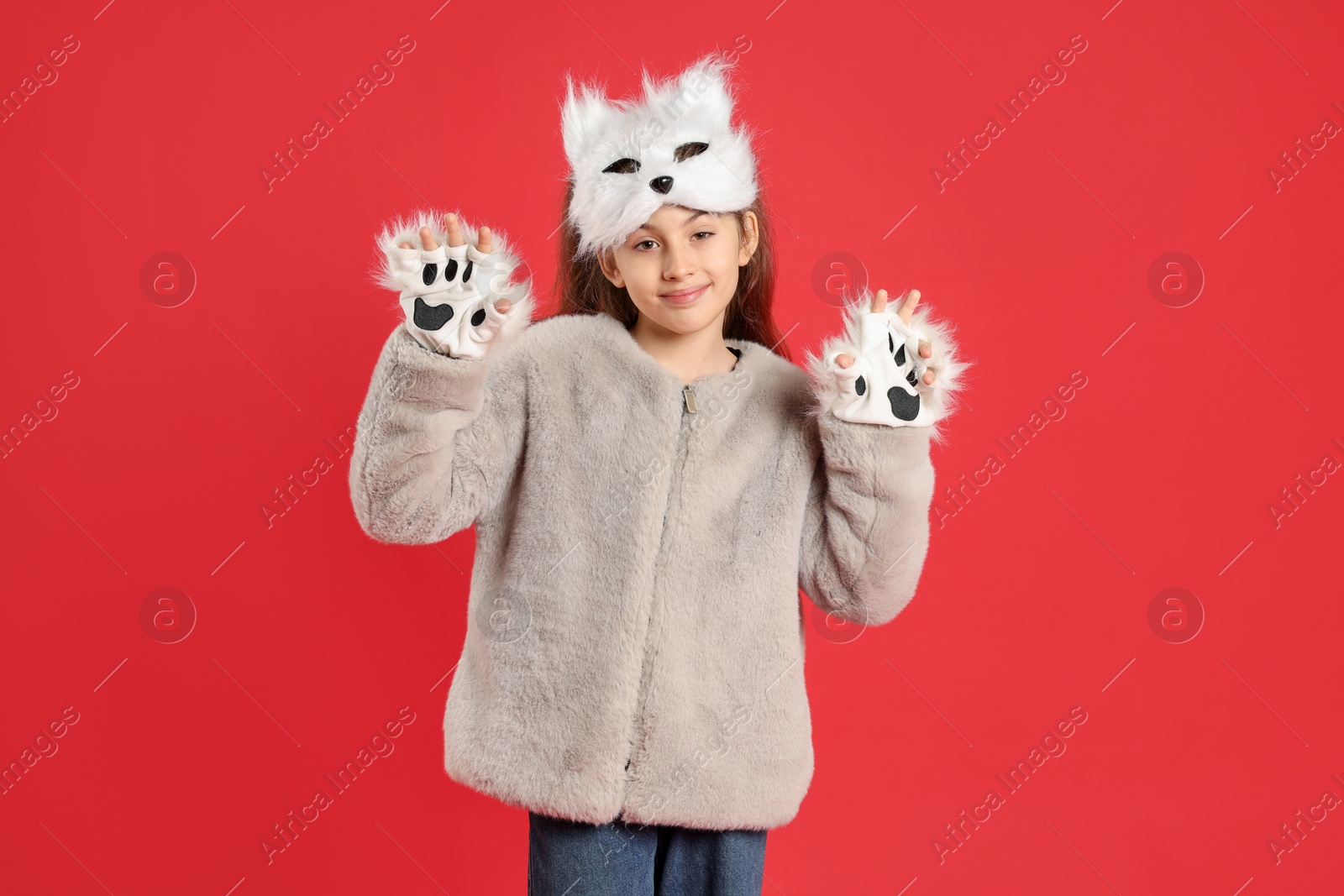 Photo of Quadrobics. Girl wearing cat mask and gloves on red background