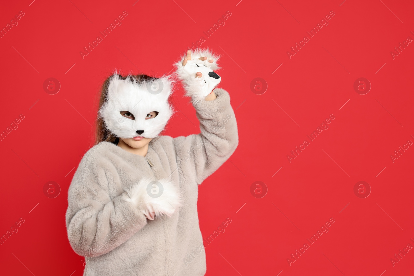 Photo of Quadrobics. Girl wearing cat mask and gloves on red background, space for text