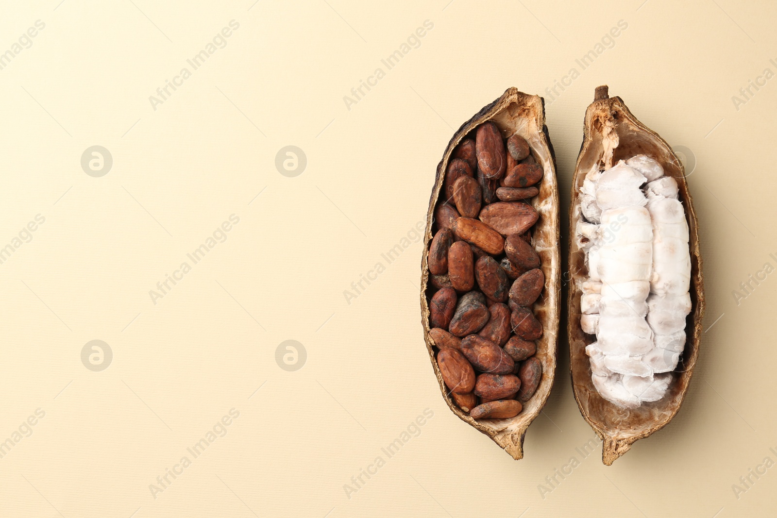 Cocoa pods with beans on beige background, top view. Space for text Photo of Cocoa pods with beans on beige background, top view. Space for text