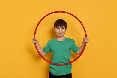 Photo of Boy with hula hoop on yellow background