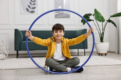 Photo of Boy with hula hoop on floor at home