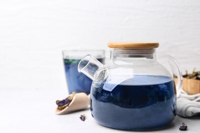 Photo of Delicious butterfly pea flower tea on white table. Space for text