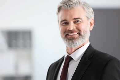 Photo of Portrait of happy banker in office, space for text