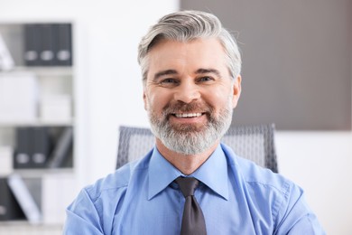 Photo of Portrait of banker in shirt at workplace