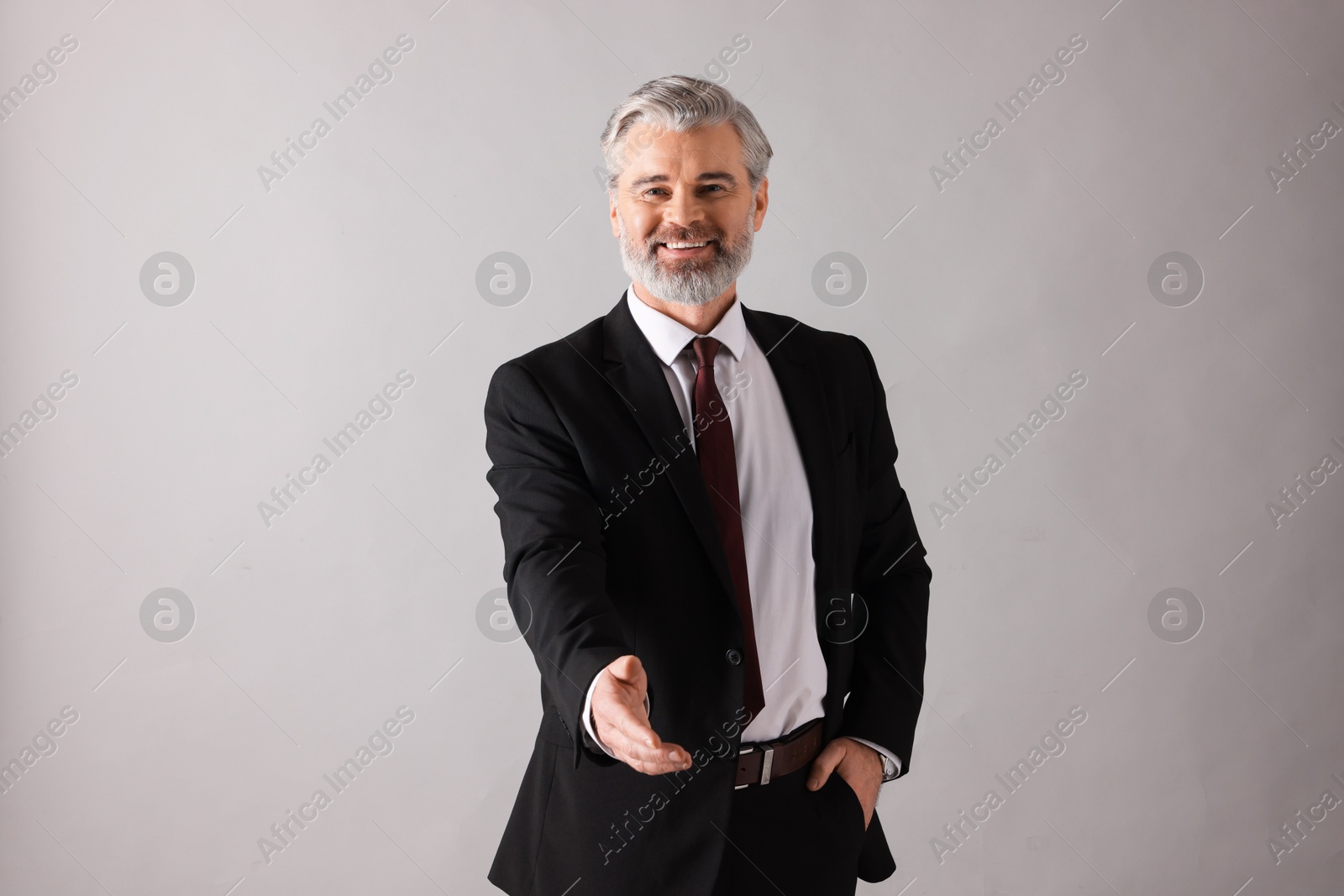 Photo of Portrait of happy banker on grey background