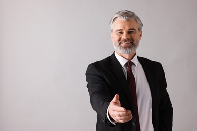 Portrait of banker on grey background, space for text