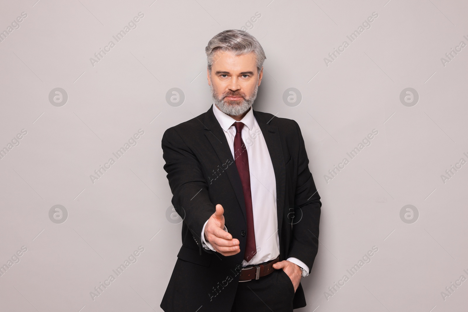 Photo of Portrait of confident banker on grey background