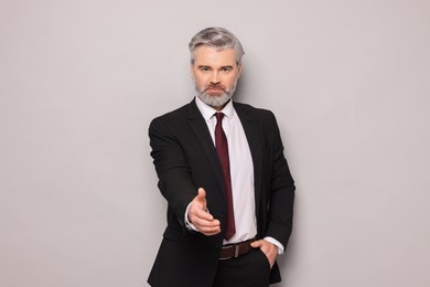 Portrait of confident banker on grey background