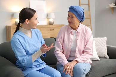 Photo of Woman with cancer and nurse at home