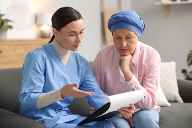 Photo of Woman with cancer and nurse at home