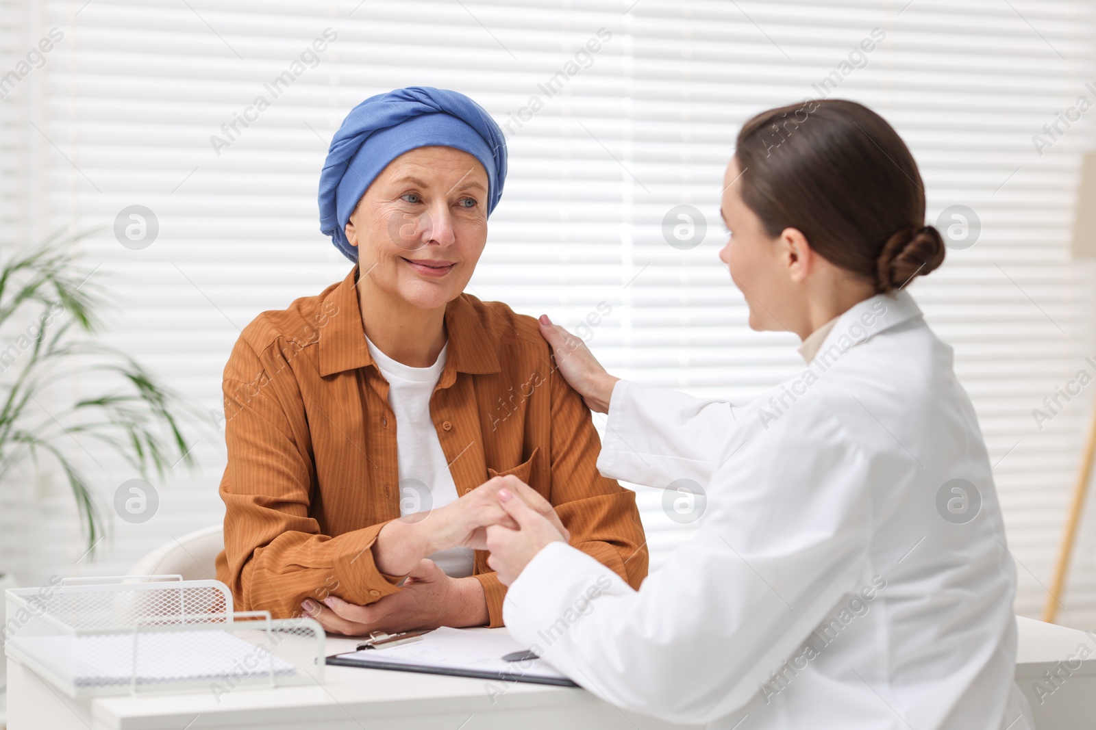 Photo of Senior woman with cancer visiting oncologist in clinic