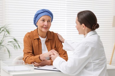 Photo of Senior woman with cancer visiting oncologist in clinic