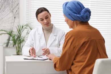 Photo of Senior woman with cancer visiting oncologist in clinic