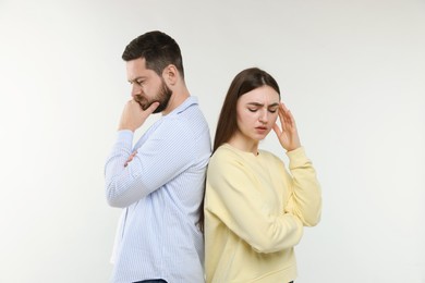 Photo of Resentful couple on light grey background. Relationship problem