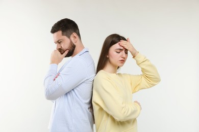 Photo of Resentful couple on light grey background. Relationship problem